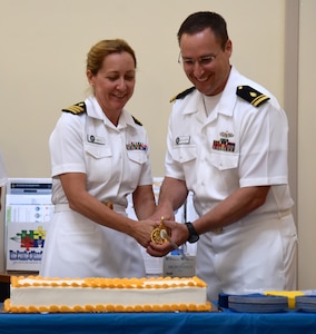 U.S. Navy Cdr. Amy Smith, director, Public Health Services, Naval Health Clinic Charleston, and Lt. j.g. Aaron Mehlberg, NHCC Radiation Health Officer, cut the cake during NHCC's birthday celebration for the Medical Service Corps Aug. 4, 2016 at NHCC, JB Charleston - WS. (Navy photo by Seaman Kelen Kloss)