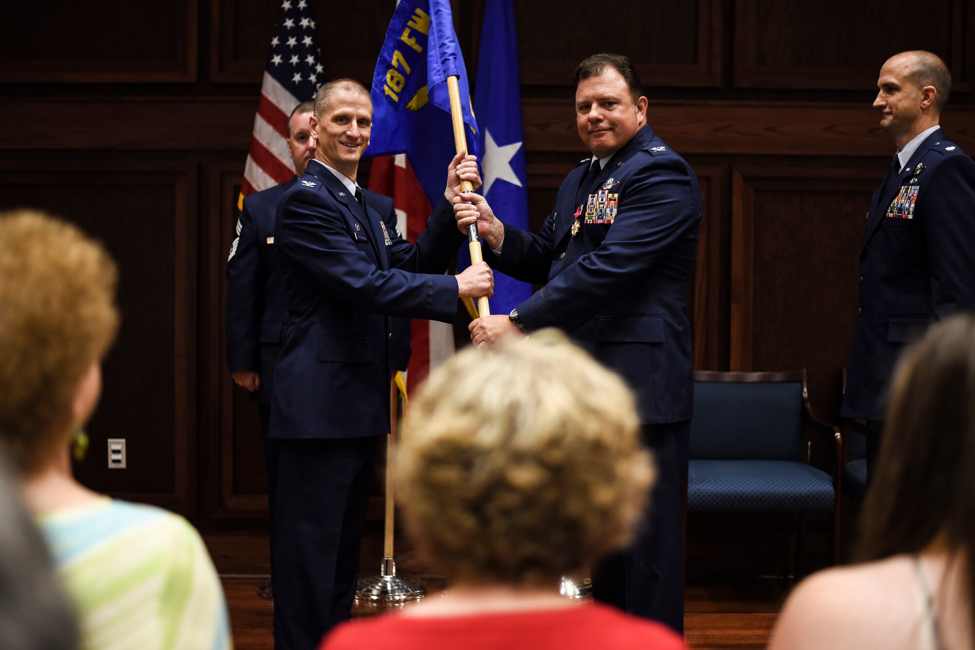 Col. Randal K. Efferson, 187th Fighter Wing commander, and Col. Clarence “Ski” Borowski, 187th Operations Group commander, pose after Borowski relinquished command of the 187th OG Aug 7, 2016, at the OG Change of Command ceremony at Montgomery Regional Air National Guard Base, Ala. Borowski’s mother Virginia, left, wife Carole, center, and daughter Cara, right, were in attendance to support him. (U.S. Air National Guard photo by Airman 1st Class Hayden Johnson)