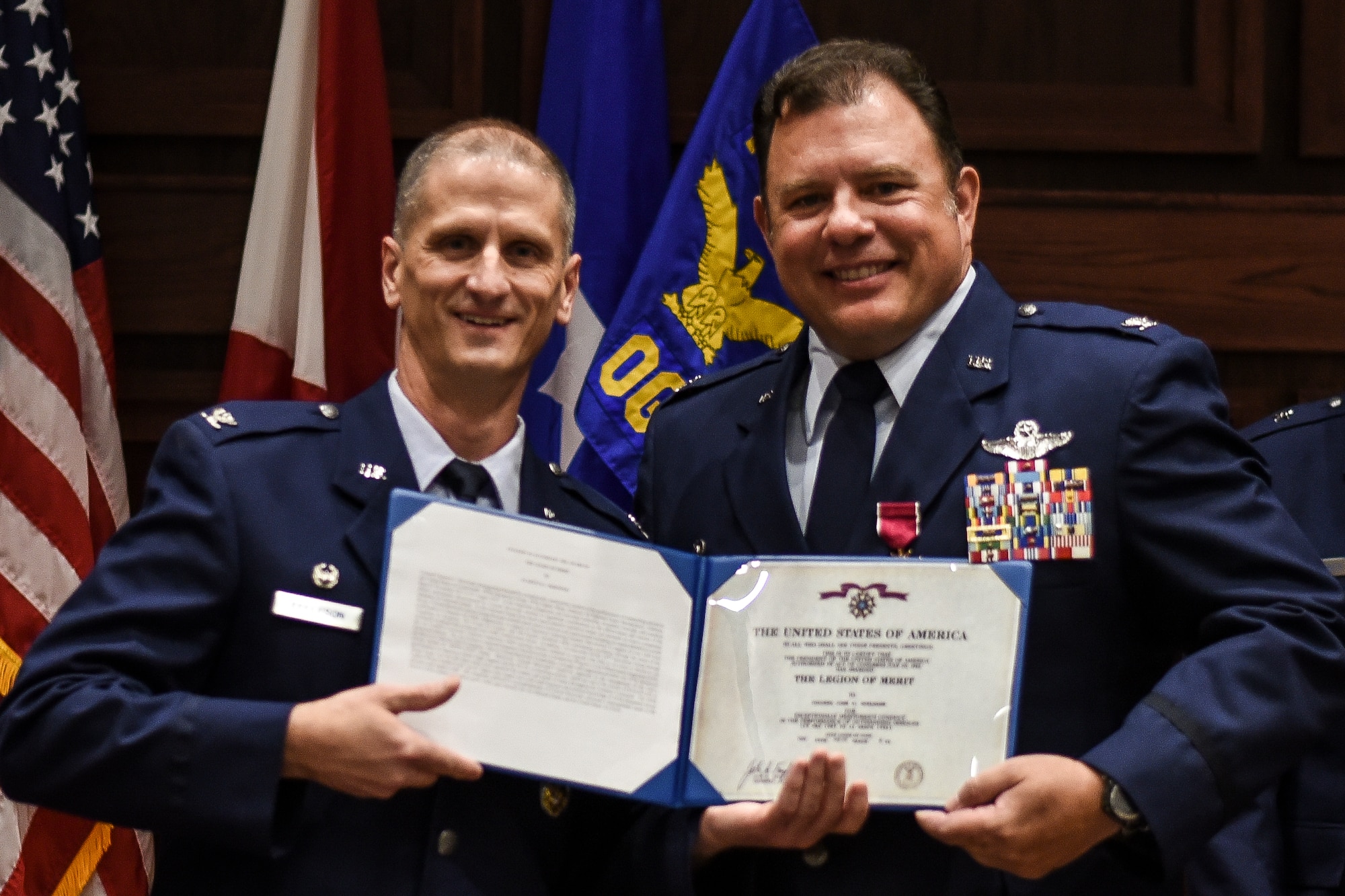 Col. Randal K. Efferson, 187th Fighter Wing commander, and Col. Clarence “Ski” Borowski, 187th Operations Group commander, pose after Borowski received the Legion of Merit Aug. 7, 2016, at the OG Change of Command ceremony at Montgomery Regional Air National Guard Base, Ala. Borowski began his career as an enlisted weapons system specialist before commissioning in 1992. He has flown the U.S. Air Force F-16 Fighting Falcon and RC-26B reconnaissance aircraft, amassing more than 4,000 flight hours. (U.S. Air National Guard photo by Airman 1st Class Hayden Johnson)