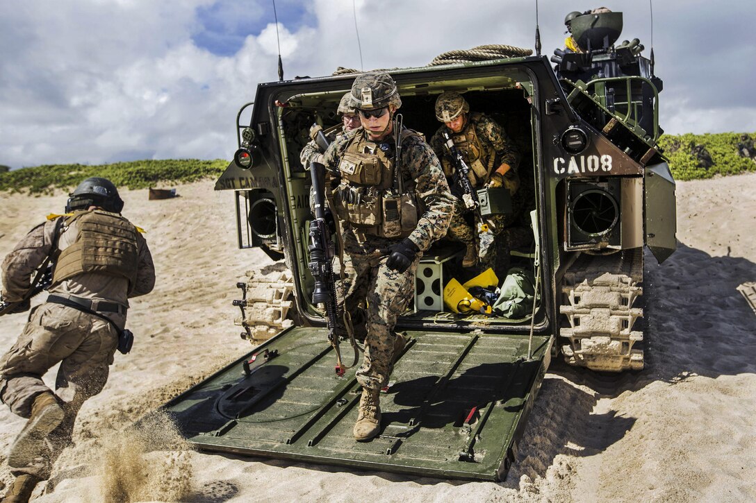 Marines exit an amphibious vehicle during Rim of the Pacific 2016, a maritime exercise in Hawaii, July 30, 2016. The Marines, assigned to Echo Company, Battalion Landing Team 2nd Battalion, 3rd Marine Regiment, launched from the USS San Diego. Marine Corps photo by Lance Cpl. Matthew Casbarro