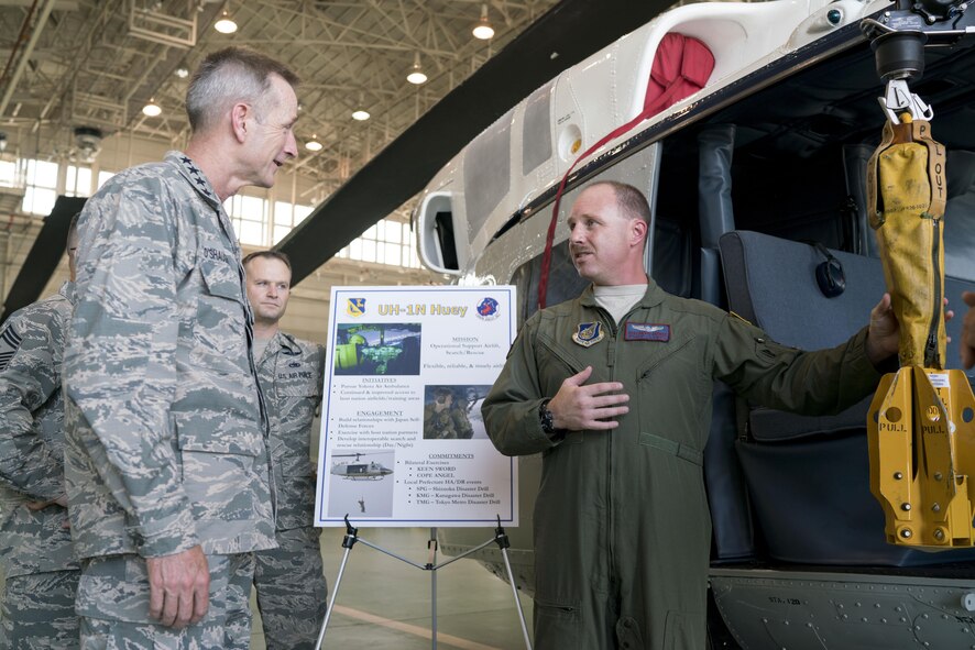 U.S. Air Force Gen. Terrence J. O'Shaughnessy, Pacific Air Forces commander, speaks with Tech. Sgt. David Jacobs, 459th Airlift Squadron flight engineer, about the capabilities of the U.S. Air Force UH-1N Iroquois at Yokota Air Base, Japan, Aug. 9, 2016. This was O'Shaughnessy’s first visit to Yokota as the commander of PACAF. (U.S. Air Force photo by Senior Airman Delano Scott) 