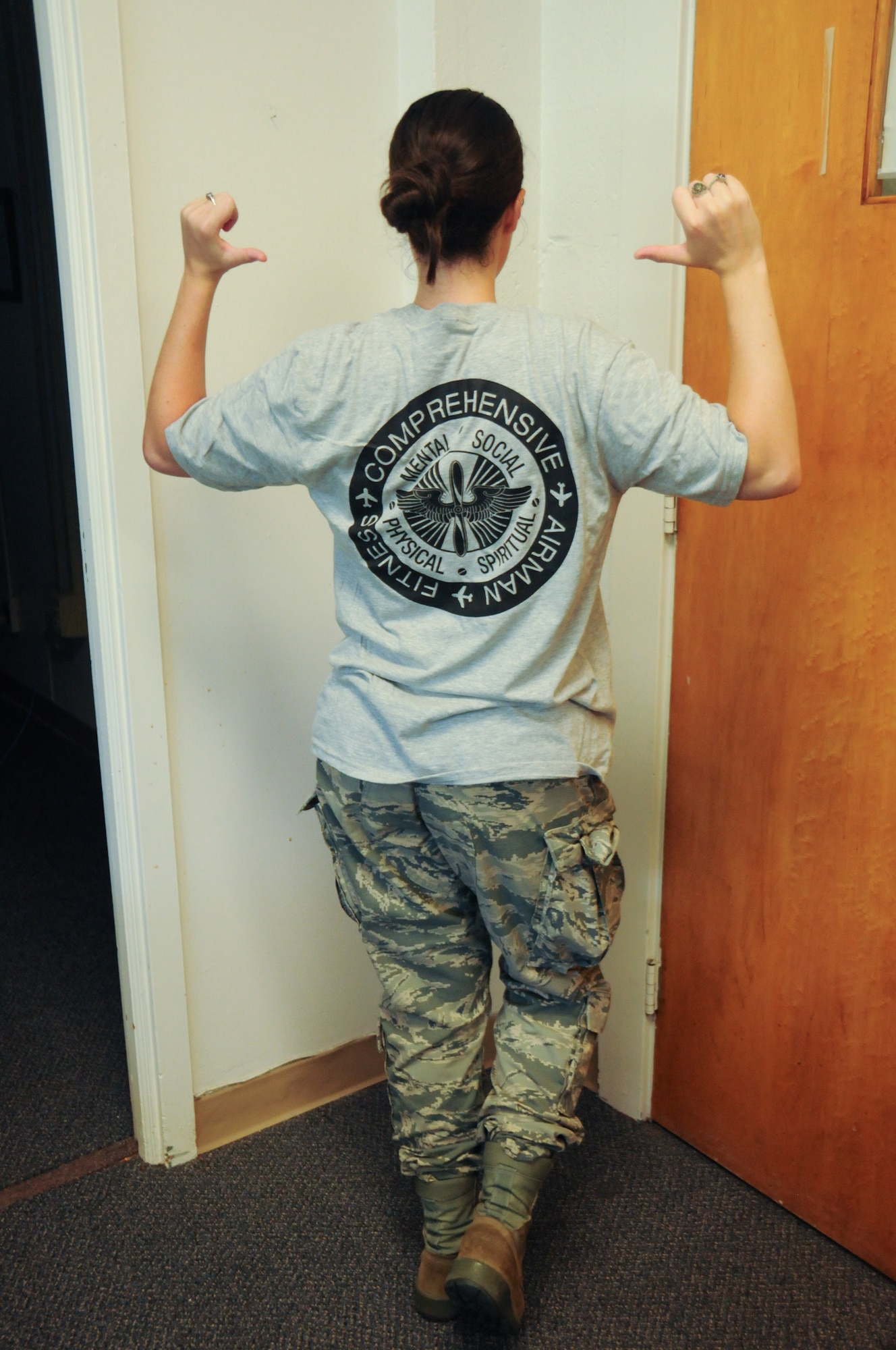 Senior Airman Devon Barbieri, the 111th Attack Wing Fitness Assessment Cell (FAC), models the installation’s official Military Color Fun Run shirt during August’s unit training assembly at Horsham Air Guard Station, Pa., Aug. 13, 2016. Participants for the event will receive a shirt upon registration. (U.S. Air National Guard photo by Senior Airman Timi Jones)
