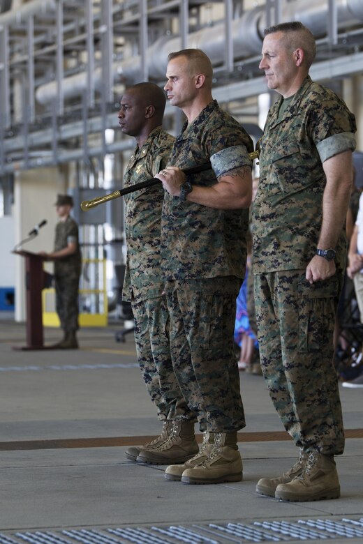 From left to right, U.S. Marine Corps Lt. Col. Jabari Reneau, commanding office of Marine All-Weather Fighter Attack Squadron (VMFA)-242, Sgt. Maj. James L. Shadle, incoming sergeant major of VMFA(AW)-242 and Sgt. Maj. Jason L. Kappen, outbound sergeant major of VMFA(AW)-242 complete the passing of the sword of office at Marine Corps Air Station Iwakuni, Japan, Aug. 12. 2016. The passing of the sword of office is a Marine Corps tradition when relieving and appointing sergeants major. (U.S. Marine Corps photo by Lance Cpl. Joseph Abrego)