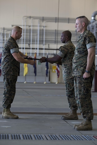 U.S. Marine Corps Lt. Col. Jabari Reneau, commanding officer of Marine All-Weather Fighter Attack Squadron (VMFA)-242, commences the passing of the sword of office to Sgt. Maj. James L. Shadle at Marine Corps Air Station Iwakuni, Japan, Aug. 12, 2016. A relief and appointment ceremony was held to welcome the incoming and see off the outbound sergeants major. (U.S. Marine Corps photo by Lance Cpl. Joseph Abrego) 