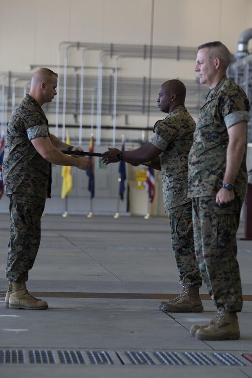 U.S. Marine Corps Lt. Col. Jabari Reneau, commanding officer of Marine All-Weather Fighter Attack Squadron (VMFA)-242, commences the passing of the sword of office to Sgt. Maj. James L. Shadle at Marine Corps Air Station Iwakuni, Japan, Aug. 12, 2016. A relief and appointment ceremony was held to welcome the incoming and see off the outbound sergeants major. (U.S. Marine Corps photo by Lance Cpl. Joseph Abrego) 