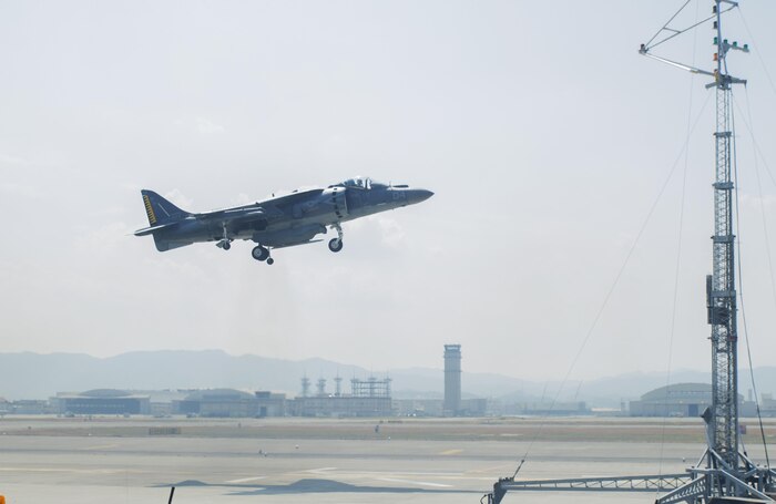 A U.S. Marine Corps AV-8B Harrier with Marine Attack Squadron (VMA) 542 performs a vertical landing while using the lights on the mobile Expeditionary Hover Position Indicator to adjust its position at Marine Corps Air Station Iwakuni, Japan, Aug. 9, 2016. VMA-542 is home based out of Marine Corps Air Station Cherry Point, N.C., and is forward deployed to MCAS Iwakuni, Japan, as part of the unit deployment program. The Harrier pilots used the mobile EHPI in coordination with Aircraft Recovery assigned to Headquarters and Headquarters Squadron to recertify on boat-deck landings to prepare for other future operations in the Pacific. (U.S. Marine Corps photo by Lance Cpl. Donato Maffin)