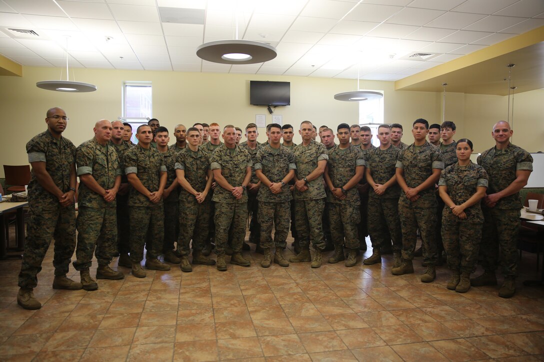Marines involved with Marine Air Control Group 28's Corporals Course, accompanied by Col. Thomas Dodds (second left), Sgt. Maj. Richard Thresher (middle left), Brig. Gen. Matthew Glavy (middle right) and Sgt. Maj. Rogelio De Leon (far right) stand together after sharing a meal at the mess hall aboard Marine Corps Air Station Cherry Point, N.C., Aug. 9, 2016. Brig. Gen. Matthew Glavy and Sgt. Maj. Richard Thresher had breakfast with the Marines while discussing leadership and the role of noncommissioned officers in mission accomplishment for the Marine Corps. Thresher is the command sergeant major and Glavy is the commanding general for 2nd Marine Aircraft Wing. Glavy is the commanding general and Thresher is the command sergeant major for 2nd Marine Aircraft Wing, while Dodds is the commanding officer for MACG-28 and De Leon is the sergeant major for Marine Tactical Air Command Squadron 28. (U.S. Marine Corps photo by Lance Cpl. Mackenzie Gibson/Released)