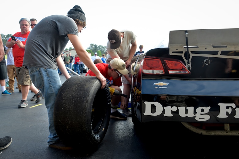 Students from Heritage High School compete in the team pit crew challenge during the annual Top Wrench competition July, 14. During the pit crew challenge three students must use provided tools to change the tire on a racecar with the fastest time to win. (U.S. Air National Guard photo by Staff Sgt. Ben Mellon)