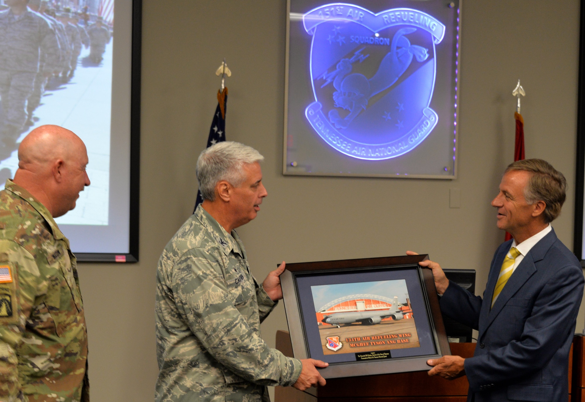 Maj. Gen. Terry M. Haston, the Adjutant General of Tennessee National Guard and Col. Thomas Cauthen, 134th Air Refueling Wing Commander present a 134th ARW picture to Tennessee Governor Bill Haslam while visiting the 134th Operations Group July 27, 2016 at McGhee Tyson ANG Base, Knoxville, Tenn. (U.S. Air National Guard photo by Staff Sgt. Daniel Gagnon)