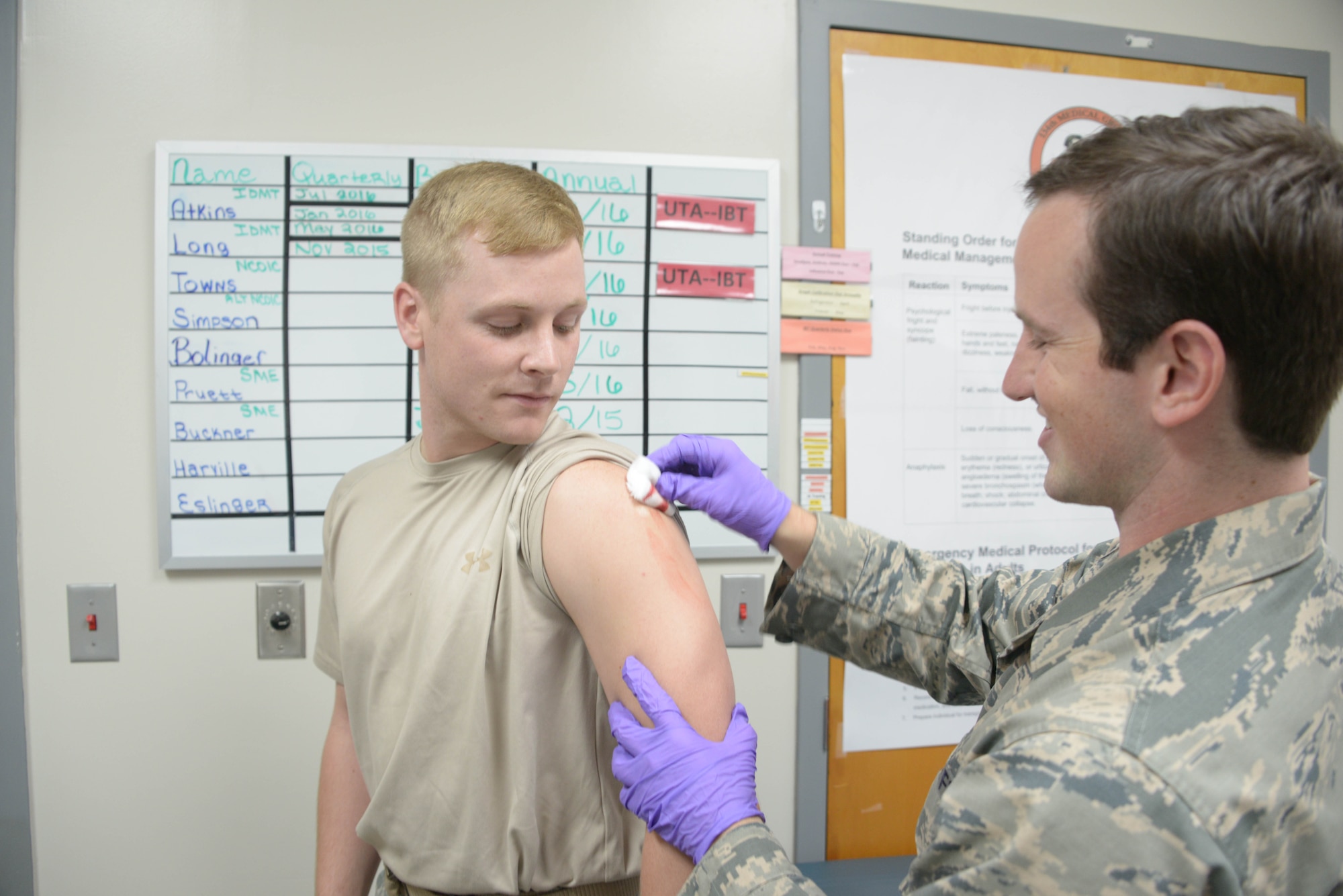 Senior Airman Walter Buckner administers an influenza vaccination for an Airman at the 134 ARW Medical Group. Senior Airman Buckner stated that it’s a very common reaction by many to be nervous around needles. (U.S. Air National Guard photos by Tech. Sgt. Jonathan Young, 134 ARW Public Affairs)