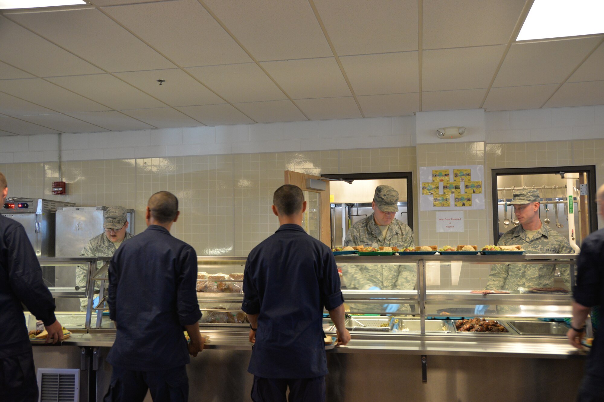 Airmen from the 134th Air Refueling Wing Force Support Squadron serve food to cadets from the Military Youth Academy at Joint Base Elmendorf- Richardson, Alaska, July 10-19. Members from FSS showed cadets a positive outlook on the military as well as the unit. (U.S. Air National Guard photo by: Senior Airman Melissa Dearstone)