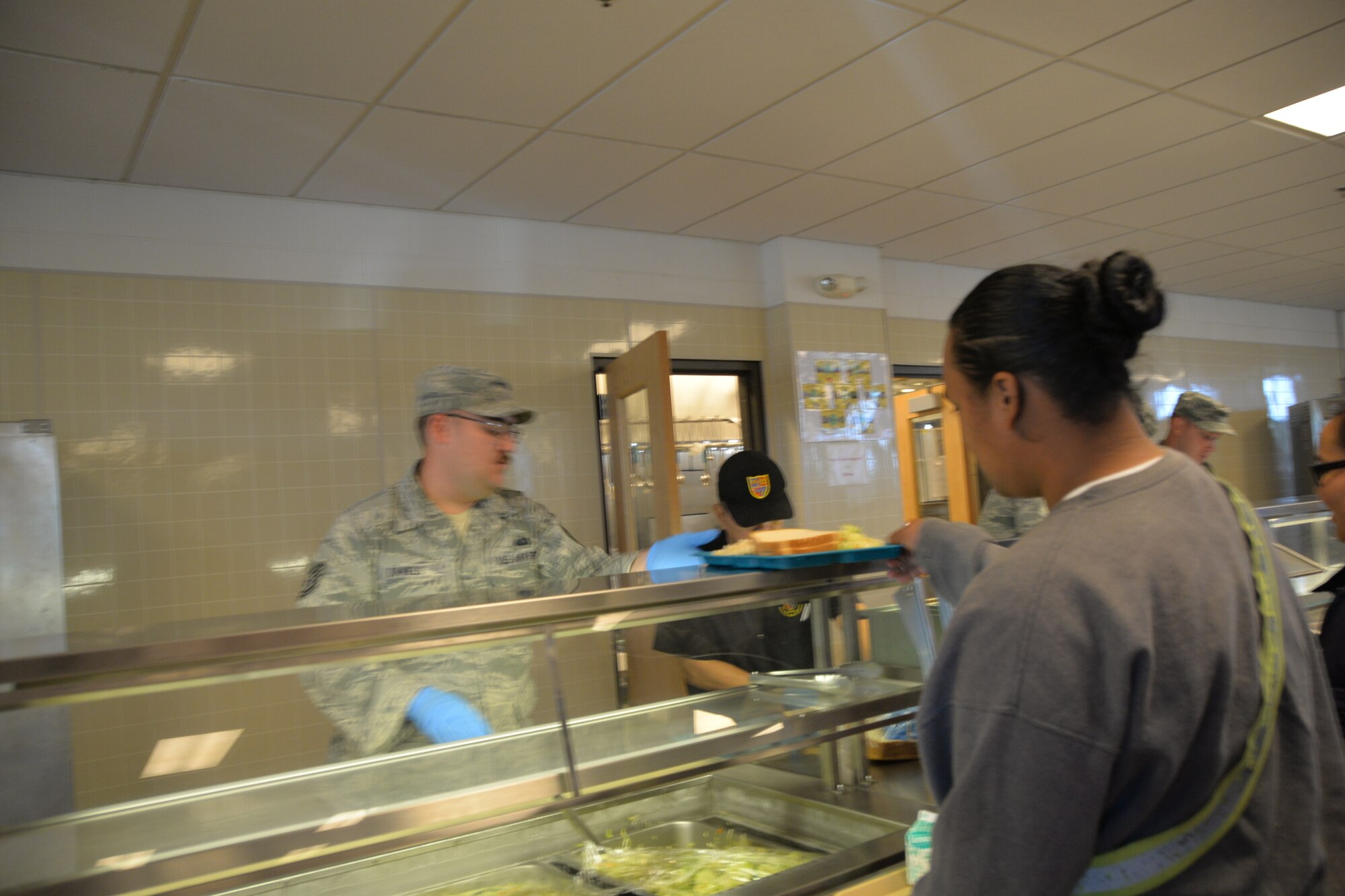 Tech. Sgt. Jacob Daniels from the 134th Air Refueling Wing Force Support Squadron volunteers at the Military Youth Academy Dining Facility during a temporary duty assignment to Joint Base Elmendorf-Richardson Alaska, July 10-19. Members from FSS helped prepare and serve food three times a day for the cadets. (U.S. Air National Guard photo by: Senior Airman Melissa Dearstone)