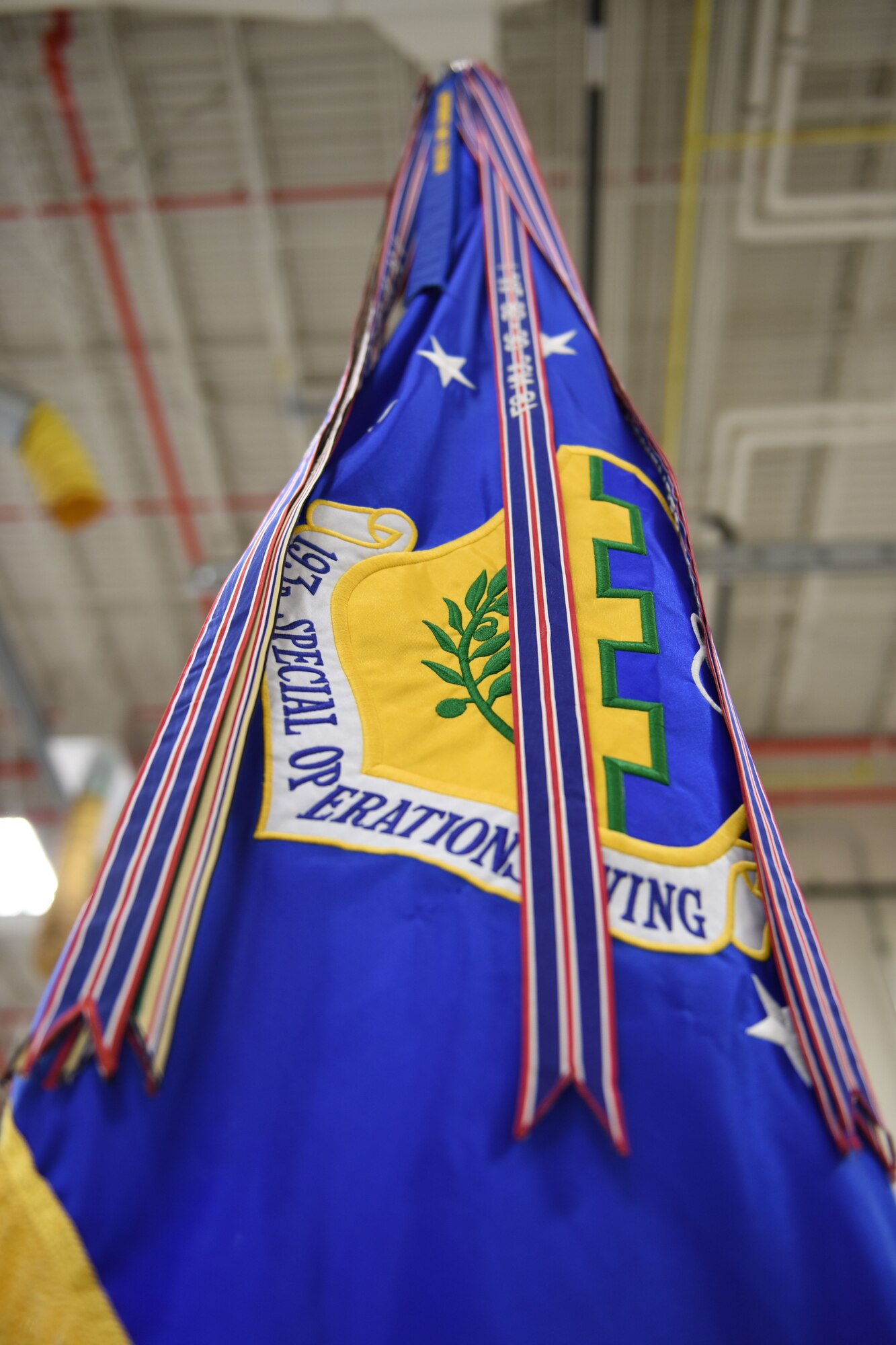 A new streamer will be added to the 193rd Special Operations Wing flag as a result of the unit's recent receipt of the 2015 Air Force Outstanding Unit Award. This streamer will join 16 others of its kind, showing the accomplishments of the wing. This honor of the AFOUA goes to units that have distinguished themselves through exceptional meritorious service or outstanding achievement that clearly sets them above and apart from their counterparts. (U.S. Air National Guard photo by Staff Sgt. Claire Behney/Released)