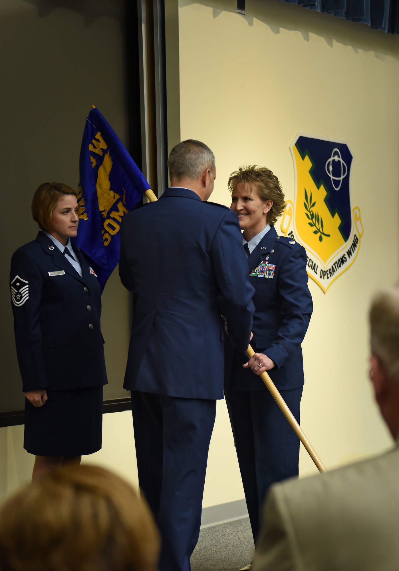 Col. Mike Cason (center), 193rd Special Operations Wing commander, presents the guidon to Lt. Col. Susan Garrett (right), the new 193rd Special Operations Mission Support Group commander, during an assumption of command ceremony Aug. 13, Middletown, Pennsylvania. The ceremony began with preliminary honors and ended with the symbolic passing of the guidon. (U.S. Air National Guard photo by Senior Airman Ethan Carl/Released)