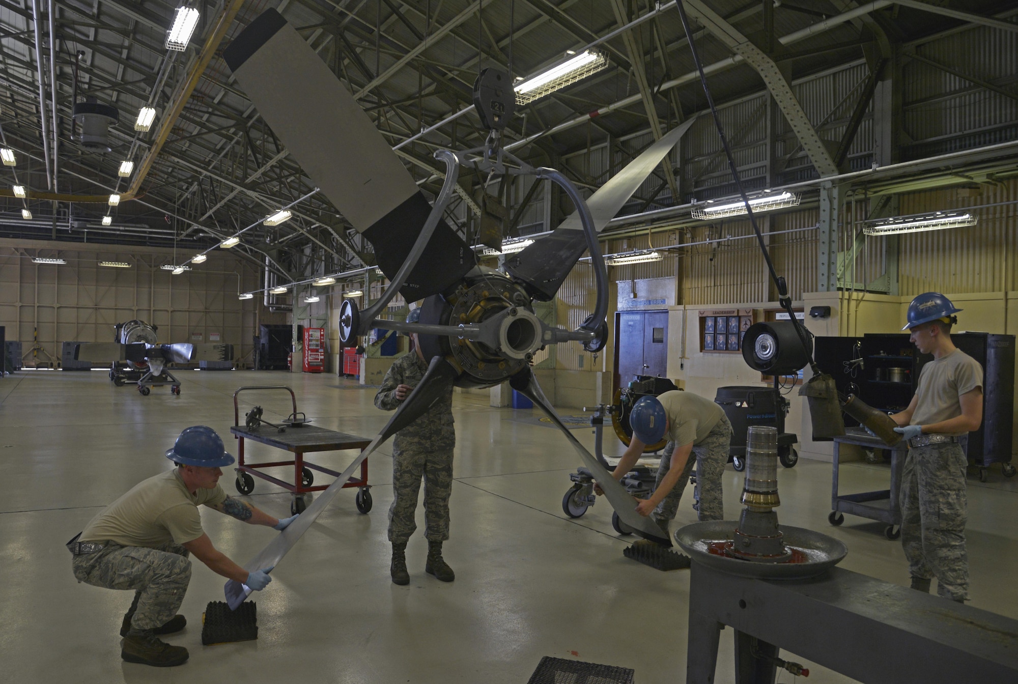 Members of the 374th Maintenance Squadron aerospace propulsion flight install a prop control onto a C-130 Hercules propeller at Yokota Air Base, Japan, Aug. 11, 2016. The flight provides engines and propellers for the C-130 Hercules, enabling airlift and humanitarian missions throughout the Indo-Asia Pacific Region. (U.S. Air Force photo by Senior Airman David Owsianka/Released)