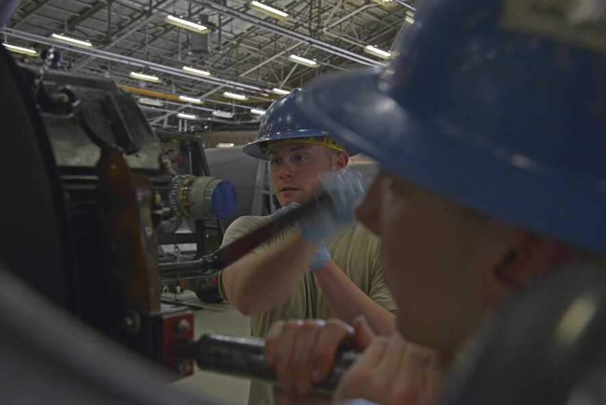 Senior Airman Colton Windsor, 374th Maintenance Squadron aerospace propulsion flight journeyman, tightens a bolt to install a prop control onto a propeller at Yokota Air Base, Japan, Aug. 11, 2016. The flight also provides engine and propeller support for Kadena Air Base and other active duty, guard and reserve C-130s that are tasked within the area of responsibility. (U.S. Air Force photo by Senior Airman David Owsianka/Released)