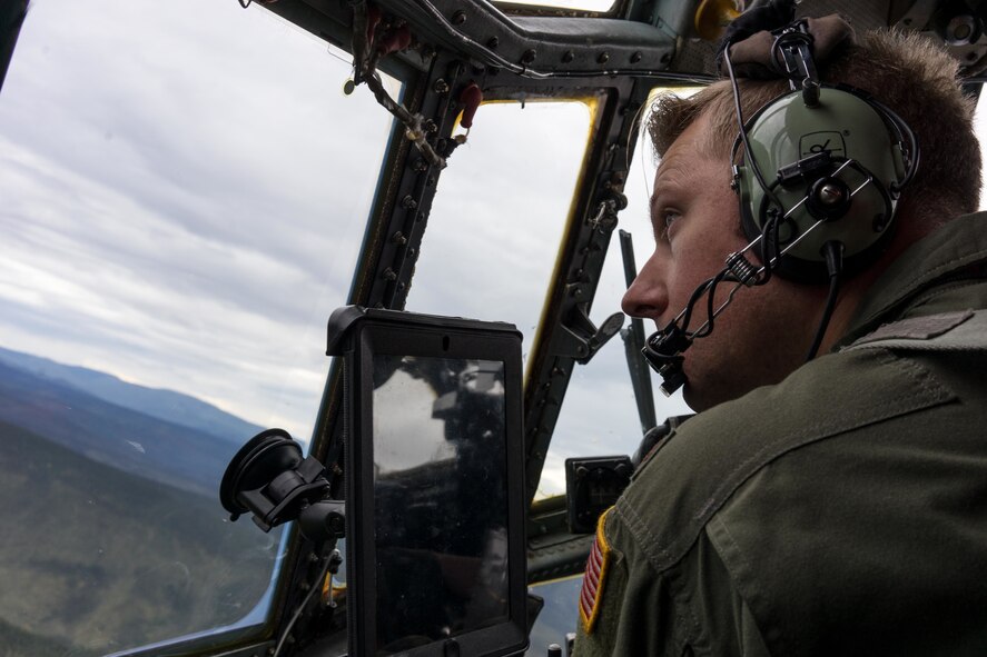 U.S. Air Force Maj. Dan Crow, 36th Airlift Squadron C-130 Hercules pilot, looks over the horizon while flying during Red Flag-Alaska at Joint Base Elmendorf-Richardson, Alaska, Aug 6, 2016. During the exercise pilots have the opportunity to fly over the training range, which allows them to fly at the minimum altitude of 300ft. (U.S. Air Force photo by Staff Sgt. Michael Smith/Released)