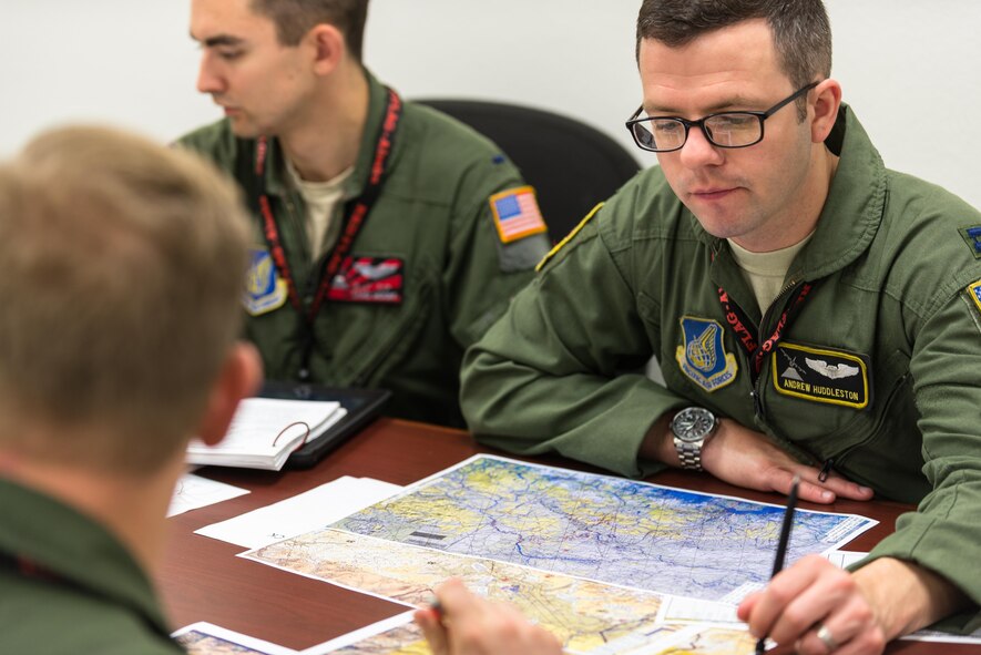 U.S. Air Force Capt. Andrew Huddleston, 36th Airlift Squadron C-130 Hercules pilot, looks over charts at a pre-flight mission briefing during Red Flag-Alaska on Joint Base Elmendorf-Richardson, Alaska, Aug 6, 2016. Red Flag-Alaska is an exercise that provides joint offensive counter-air, interdiction, close air support and large force employment training in a simulated combat environment. (U.S. Air Force photo by Staff Sgt. Michael Smith/Released)