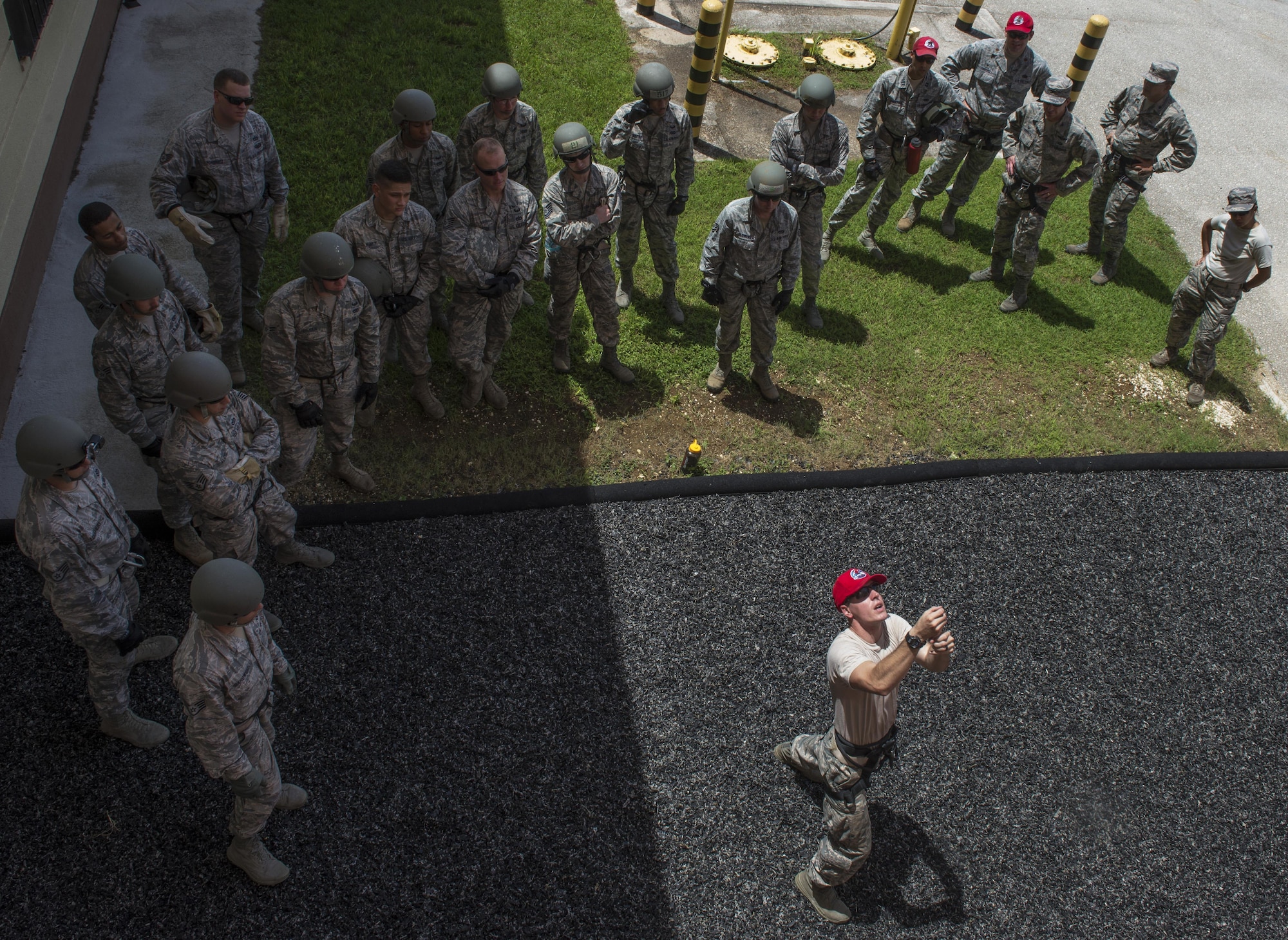 Staff Sgt. Joshua Krahenbuhl, 554th RED HORSE Squadron team NCO in charge, briefs belaying safety procedures before training Aug. 9, 2016, at Naval Base Guam. The purpose of the rappel training was to provide real-world training for 554th RHS members. RED HORSE units provide a highly responsive force to support contingency, peacetime and humanitarian operations world-wide. (U.S. Air Force photo by/Master Sgt. JT May III)