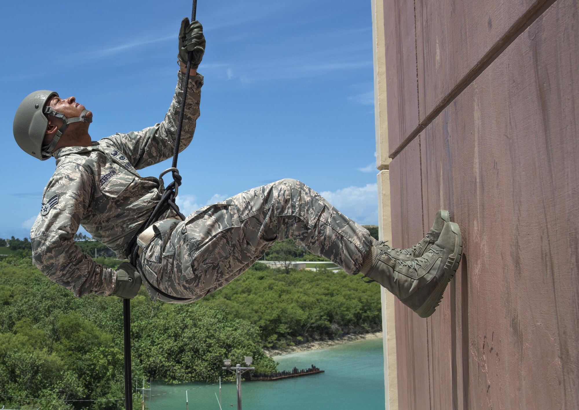 Senior Airman Brandon Jefferson, 554th RED HORSE Squadron operations control, awaits instruction while rappelling down a 90-foot tower Aug. 9, 2016, at Naval Base Guam. The purpose of the rappel training was to provide real-world training for 554th RHS members. RED HORSE units provide a highly responsive force to support contingency, peacetime and humanitarian operations world-wide. (U.S. Air Force photo by Master Sgt. JT May III)