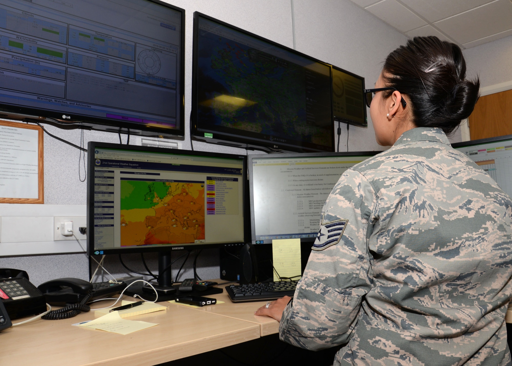 U.S. Air Force Staff. Sgt. Marissa Munguia, 100th Operations Support Squadron weather forecaster, analyzes the weather impacts for the day Aug. 8, 2016, on RAF Mildenhall, England. Munguia constantly monitors the weather for any changes in order to brief the various units which require this information. (U.S. Air Force photo by Gina Randall)
