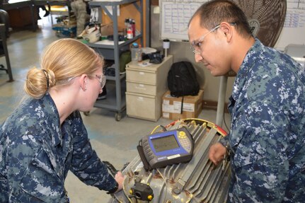 Machinist Mate 3rd Class Brittany Alldredge and Machinist Mate 1st Class (SW) Raul Coronado prepare to measure the shaft alignment on a firemain pump. Before returning the pumps to the fleet, SERMC Sailors use precision laser alignment systems to ensure the shaft of the motor and pump are properly aligned along horizontal and vertical planes. Photo by Scott Curtis.