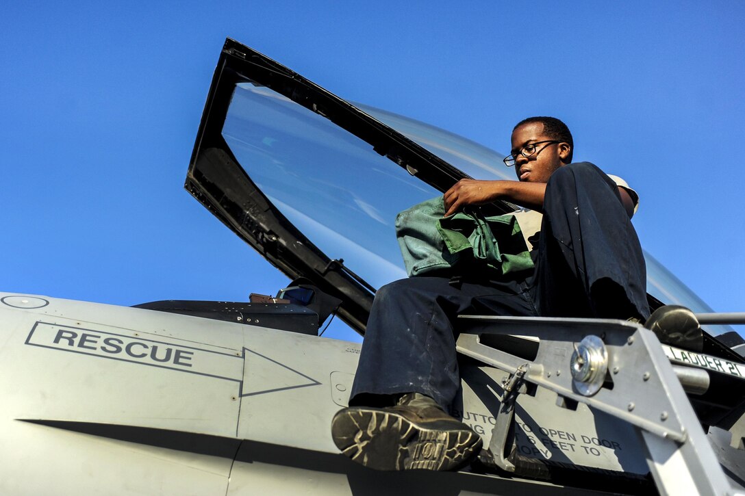 Air Force Airman 1st Class Obadiyah Ivens prepares the cockpit of an F-16 Fighting Falcon during Green Flag 16-08 at Nellis Air Force Base, Nev., Aug. 2, 2016. Ivens is a crew chief assigned to the 555th Fighter Squadron, deployed from Aviano Air Force Base, Italy. Green Flag 16-08 is a U.S. Air Force, Army and Navy exercise designed that prepares participants for complex aerial combat scenarios while supporting high-intensity ground and sea operations. Air Force photo by Airman 1st Class Kevin Tanenbaum