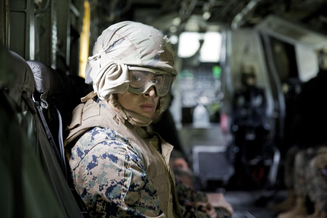 A U.S. Marine assigned to Logistics Operations School (LOS), Marine Corps Combat Service Support Schools, looks out from the rear opening of a CH-53E Super Stallion before conducting a Helicopter Support Team (HST) exercise at Camp Lejeune, N.C., July 19, 2016. Students attending LOS performed HST exercises as part of their required entry-level training. (U.S. Marine Corps photo by Lance Cpl. Manuel A. Serrano)