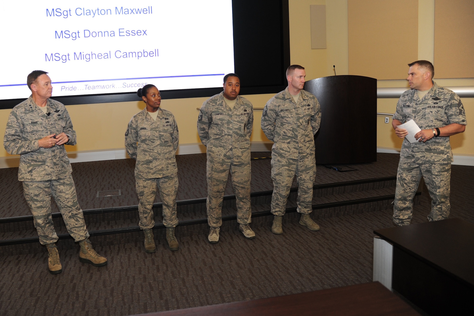 Air Force District of Washington Commander Maj. Gen. Darryl Burke and CMSgt. Tommy Mazzone, AFDW Command Chief, recognize MSgt. Donna Essex, MSgt Migheal Campbell and MSgt. Clayton Maxwell for their support of the 2016 SNCO Induction Ceremony during the AFDW Commander's Call on Aug. 12, 2016. The event recognized recent individual and team accomplishments while focusing on the significant challenges facing the AFDW team over the next few months. (U.S. Air Force photo/Jim Lotz)