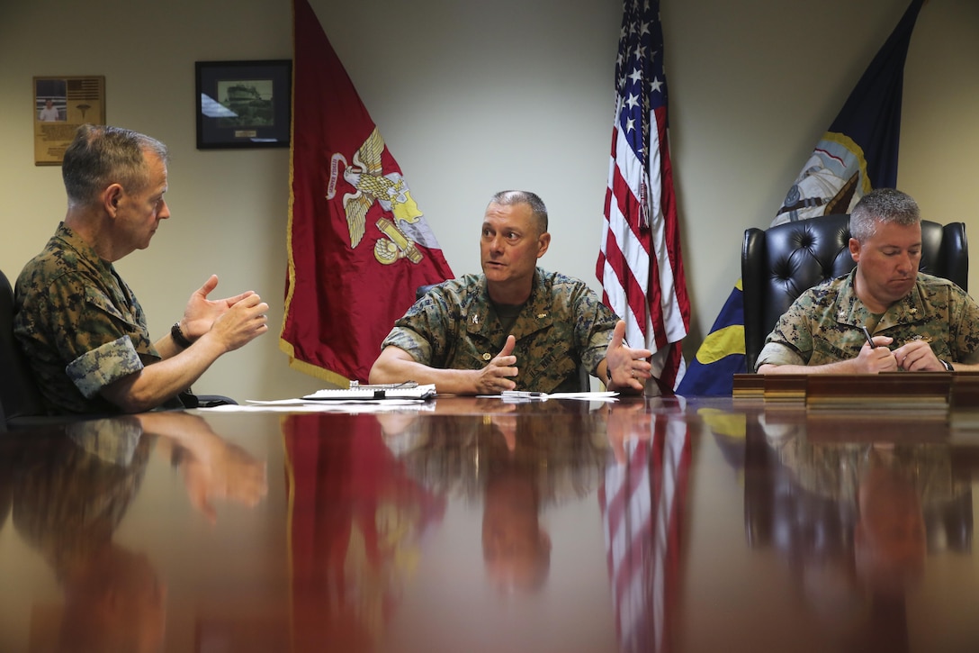 Navy Rear Adm. Stephen Pachuta, left, the Medical Officer of the Marine Corps, speaks to Navy Capt. Brian Tolbert, center, and Navy Cmdr. Kevin Bailey, right, at Camp Lejeune, N.C., Aug. 9. Tolbert is the commanding officer and Bailey is the executive officer of 2nd Medical Battalion. Pachuta visited several units throughout II Marine Expeditionary Force to evaluate medical readiness and establish solutions to current issues. (U.S. Marine Corps photo by Sgt. Lucas Hopkins)