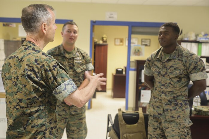 Navy Rear Adm. Stephen Pachuta, left, the Medical Officer of the Marine Corps, speaks to Hospitalman 1st Class Walter Wiencek, center, and Hospitalman 3rd Class Francis Nukpoafe, right, both with 2nd Medical Battalion, at Camp Lejeune, N.C., Aug. 9, 2016. Pachuta addressed medical readiness and operational procedures with key leaders from throughout II Marine Expeditionary Force, while also greeting corpsman with various units. (U.S. Marine Corps photo by Sgt. Lucas Hopkins)