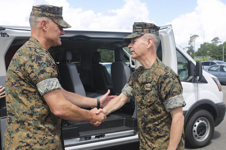 Navy Rear Adm. Stephen Pachuta, right, the Medical Officer of the Marine Corps, shakes hands with Navy Capt. Brian Tolbert, left, the commanding officer of 2nd Medical Battalion, at Camp Lejeune, N.C., Aug. 9. Pachuta addressed medical readiness and operational procedures with key leaders from throughout II Marine Expeditionary Force, while also greeting corpsman with various units. (U.S. Marine Corps photo by Sgt. Lucas Hopkins)