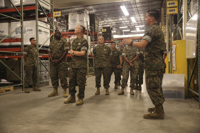 Navy Rear Adm. Stephen Pachuta, center, the Medical Officer of the Marine Corps, is briefed on medical supplies and equipment at Camp Lejeune, N.C., Aug. 11. Pachuta addressed medical readiness and operational procedures with key leaders from throughout II Marine Expeditionary Force, while also greeting corpsman with various units. (U.S. Marine Corps photo by Sgt. Lucas Hopkins)