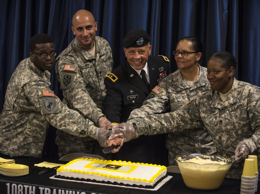 Maj. Gen. (ret.) David Puster along with Soldiers from the 108th Training Command (IET) cut a cake following his retirement ceremony at the 108th Training Command (IET) headquarters in Charlotte, N.C., Aug. 13. (U.S. Army Reserve photo by Sgt. 1st Class Brian Hamilton)