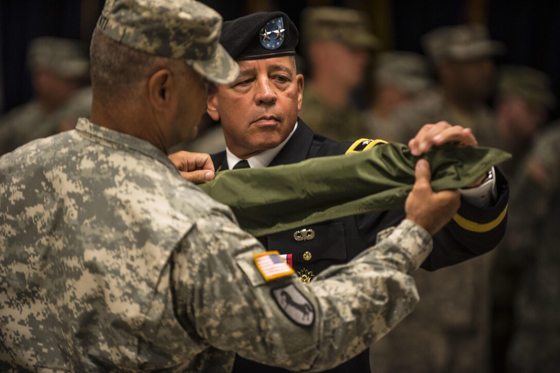 Maj. Gen. (ret.) David Puster along with Command Sgt. Maj. Robert Riti108th Training Command (IET) command sgt. maj., cases his two-star flag during his retirement ceremony at the 108th Training Command (IET) headquarters in Charlotte, N.C., Aug. 13. (U.S. Army Reserve photo by Sgt. 1st Class Brian Hamilton)