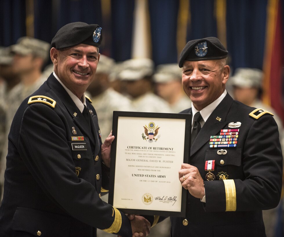 Maj. Gen. Mark McQueen, 108th Training Command (IET) commanding general, presents retired Maj. Gen. David Puster with his official certficate of retirement marking 30 years of service to the nation during a ceremony held at the 108th Training Command (IET) headquarters in Charlotte, N.C., Aug. 13.(U.S. Army Reserve photo by Sgt. 1st Class Brian Hamilton)