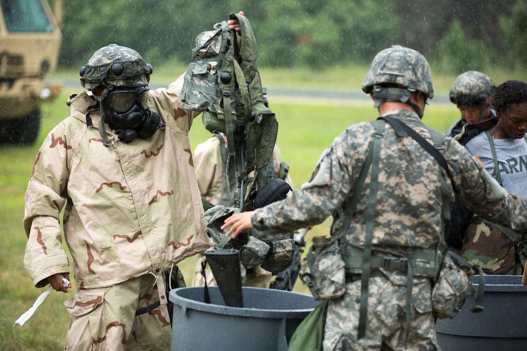 U.S. Army Reserve Spc. Christopher Angel, 411th Chemical Company, Edison, N.J., removes equipment for decontamination after a simulated chemical attack as part of a Combat Support Training Exercise at Fort McCoy, Wis., August 12, 2016. The 84th Training Command’s third and final Combat Support Training Exercise of the year hosted by the 86th Training Division at Fort McCoy, Wis. is a multi-component and joint endeavor aligned with other reserve component exercises. (U.S. Army photo by Sgt. Robert Farrell/Released)