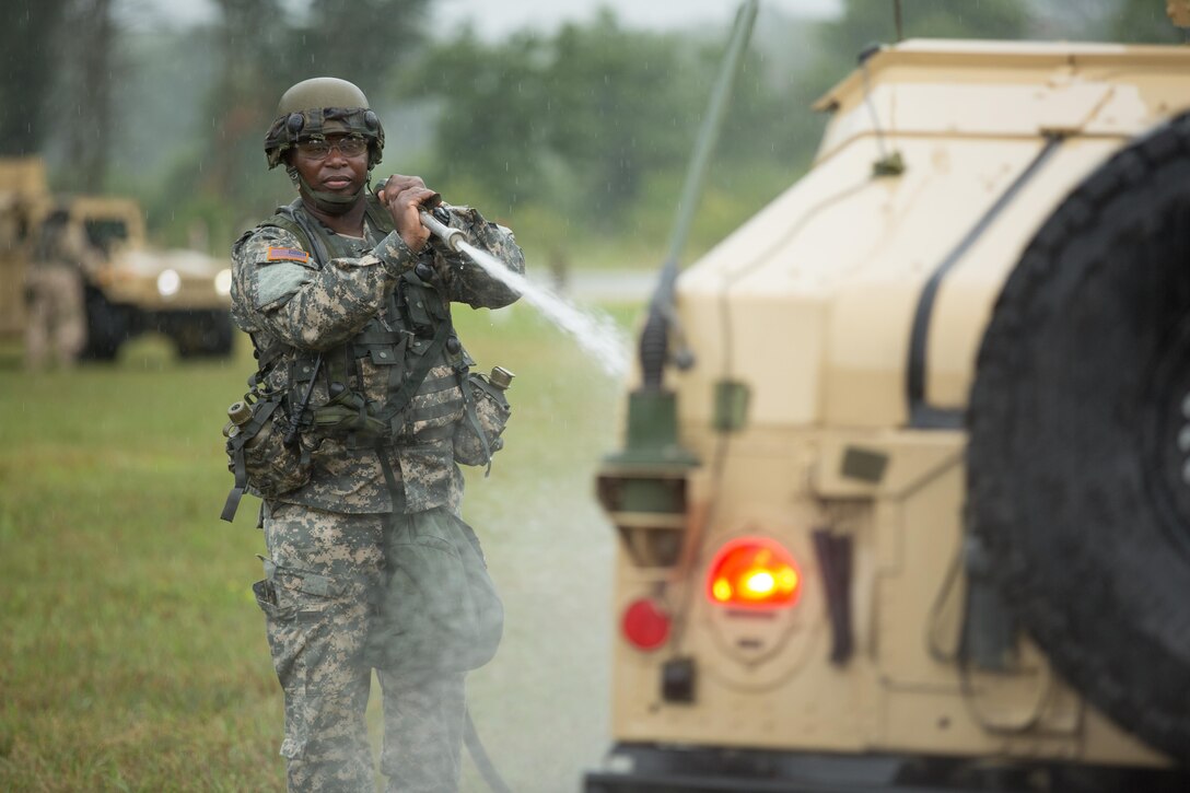 Sgt. Sheldon Paul, 411th Chemical Company, Edison, N.J., sprays a vehicle to remove contaminates during chemical training as part of a Combat Support Training Exercise at Fort McCoy, Wis., August 12, 2016. The 84th Training Command’s third and final Combat Support Training Exercise of the year hosted by the 86th Training Division at Fort McCoy, Wis. is a multi-component and joint endeavor aligned with other reserve component exercises. (U.S. Army photo by Sgt. Robert Farrell/Released)