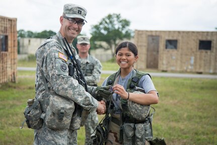 U.S. Army Cpt. Jared Budenski, 3-340th Brigade Engineer Battalion, 181st Infantry Brigade, gives a challenge coin to Spc. Jilienne Landicho, 411th Chemical Company, Edison N.J., for outstanding performance while conducting a chemical reconnaissance lane during Combat Support Training Exercise (CSTX) 86-16-03 at Fort McCoy, Wis., August 12, 2016. The 84th Training Command’s third and final Combat Support Training Exercise of the year hosted by the 86th Training Division at Fort McCoy, Wis. is a multi-component and joint endeavor aligned with other reserve component exercises. (U.S. Army photo by Spc. John Russell/Released)