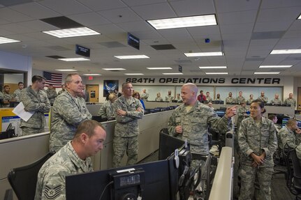 General Mark Welsh (Ret.) receives a cyber operations brief from Col. Mike Dombrowski, 624th commander, during the former CSAF's second and final visit to 24th Air Force Aug 2015. 