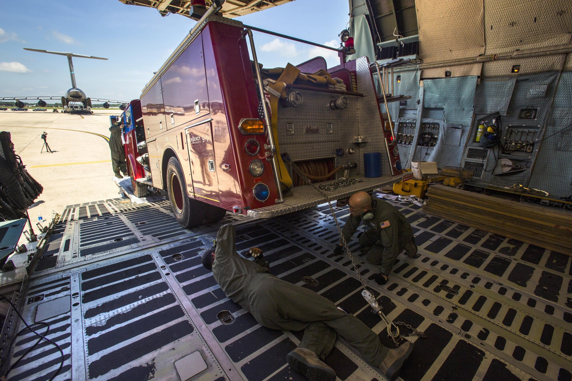 Loadmasters with the 439th Airlift Wing secure a 1982 Mack fire truck onto a C-5B Galaxy at Joint Base McGuire-Dix-Lakehurst, New Jersey, on Aug. 12, 2016. Master Sgt. Jorge A. Narvaez, a New Jersey Air National Guardsman with the 108th Security Forces Squadron, was instrumental in getting the truck donated to a group of volunteer firefighters in Managua, Nicaragua. The 439th AW is located at Westover Air Reserve Base, Mass.