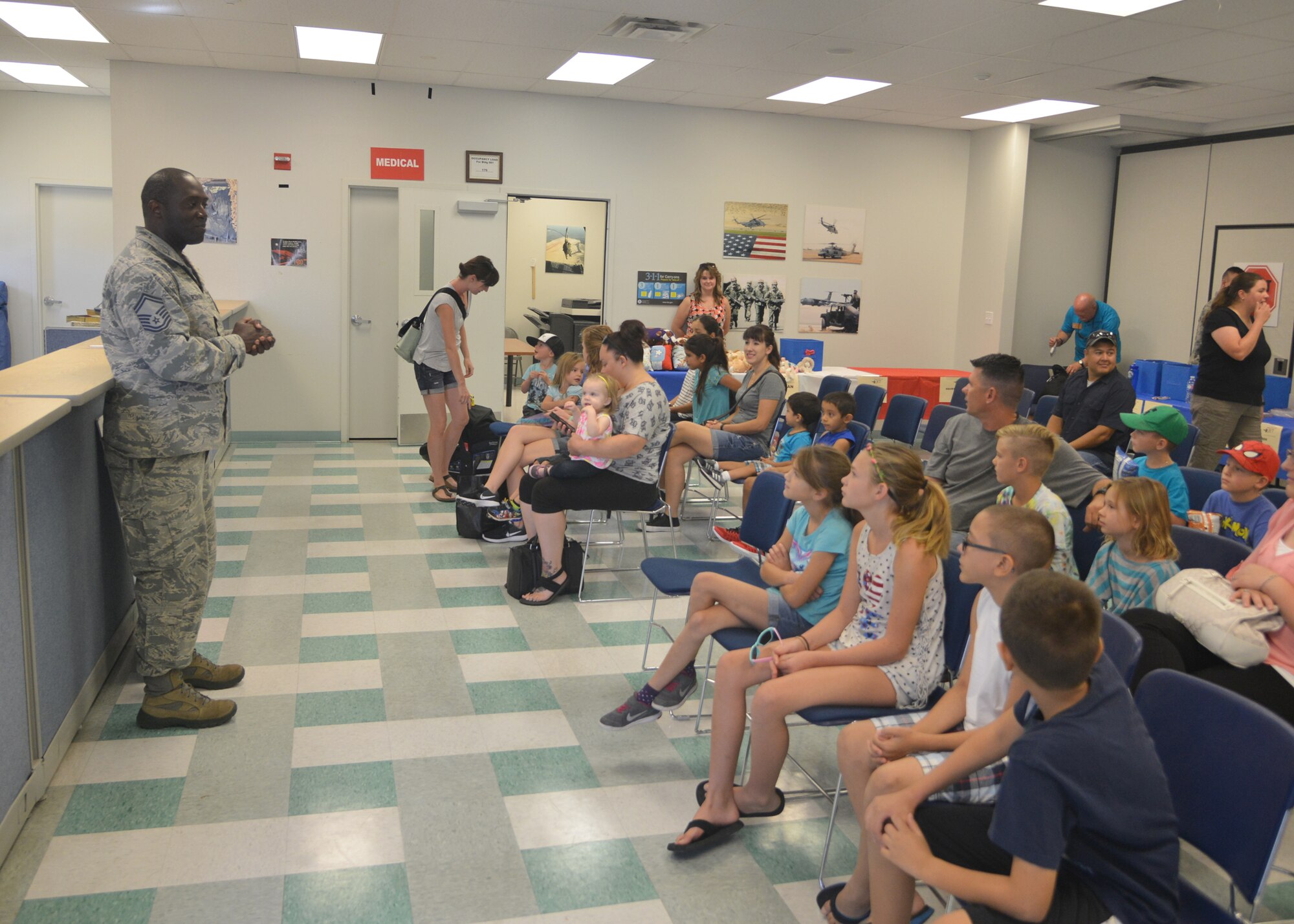 Senior Master Sgt. Maurice Robinson, 377th Force Support Squadron senior enlisted advisor, gives children a pre-deployment briefing. Hearts Apart hosts a Youth Deployment Line every year to gives kids from military families an opportunity to learn about the deployment process. (Photo by Todd Berenger)