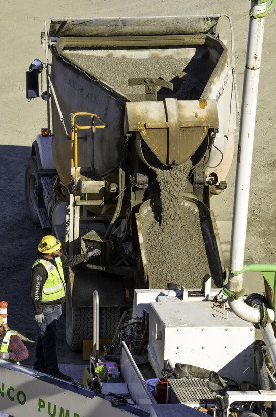 U.S. Army Corps of Engineers Sacramento District contractors prepare to place some of the 293,000 cubic yards of concrete that now line the Joint Federal Project at Folsom Lake, California. (Photo by Rick Brown)