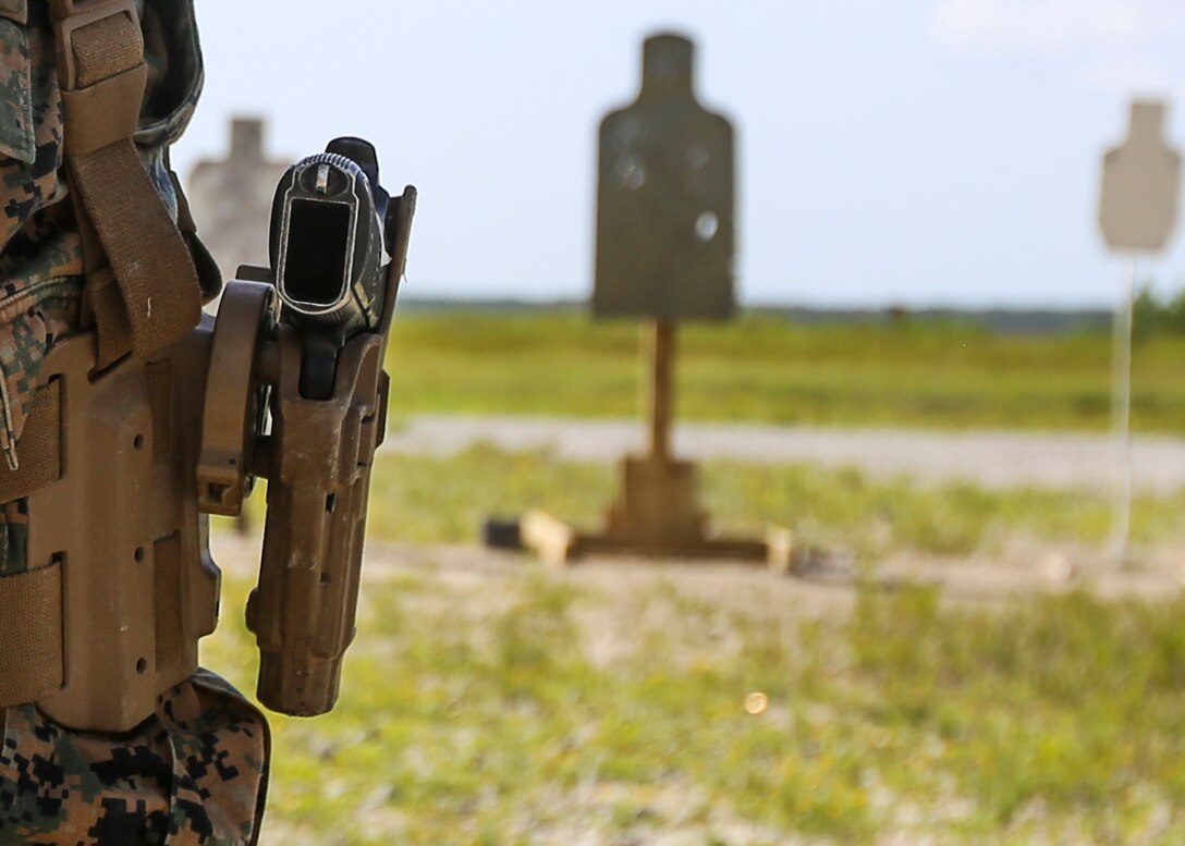 A Beretta M9 pistol sits holstered on the hip of a Marine with 2nd Law Enforcement Battalion during a weeklong weapon training exercise at Camp Lejeune, N.C., August 9. Marines advanced to the firing line where they stood facing their targets waiting to firing pistols in several drills designed to enhance their skills with the weapon. (U.S. Marine Corps photo by Lance Cpl. Aaron K. Fiala)