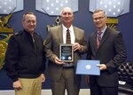 Mr. William Houchins, Naval Surface Warfare Center Dahlgren Division (NSWCDD), center, is awarded the Department of the Navy Test and Evaluation Lifetime Achievement Award from Rear Adm. Mathias Winter N84, and Mr. Rick Quade, SES, DASN (RDT&E)/N84C. 