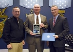 Mr. William Houchins, Naval Surface Warfare Center Dahlgren Division (NSWCDD), center, is awarded the Department of the Navy Test and Evaluation Lifetime Achievement Award from Rear Adm. Mathias Winter N84, and Mr. Rick Quade, SES, DASN (RDT&E)/N84C. 