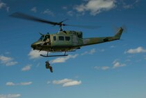 A Team Minot Airman is hoisted in a UH-1N Iroquois during survival, evasion, resistance and escape training in Garrison, N.D., Aug. 11, 2016. The all-day training focused on search and rescue situations for aircrew members. (U.S. Air Force photo/Senior Airman Apryl Hall)