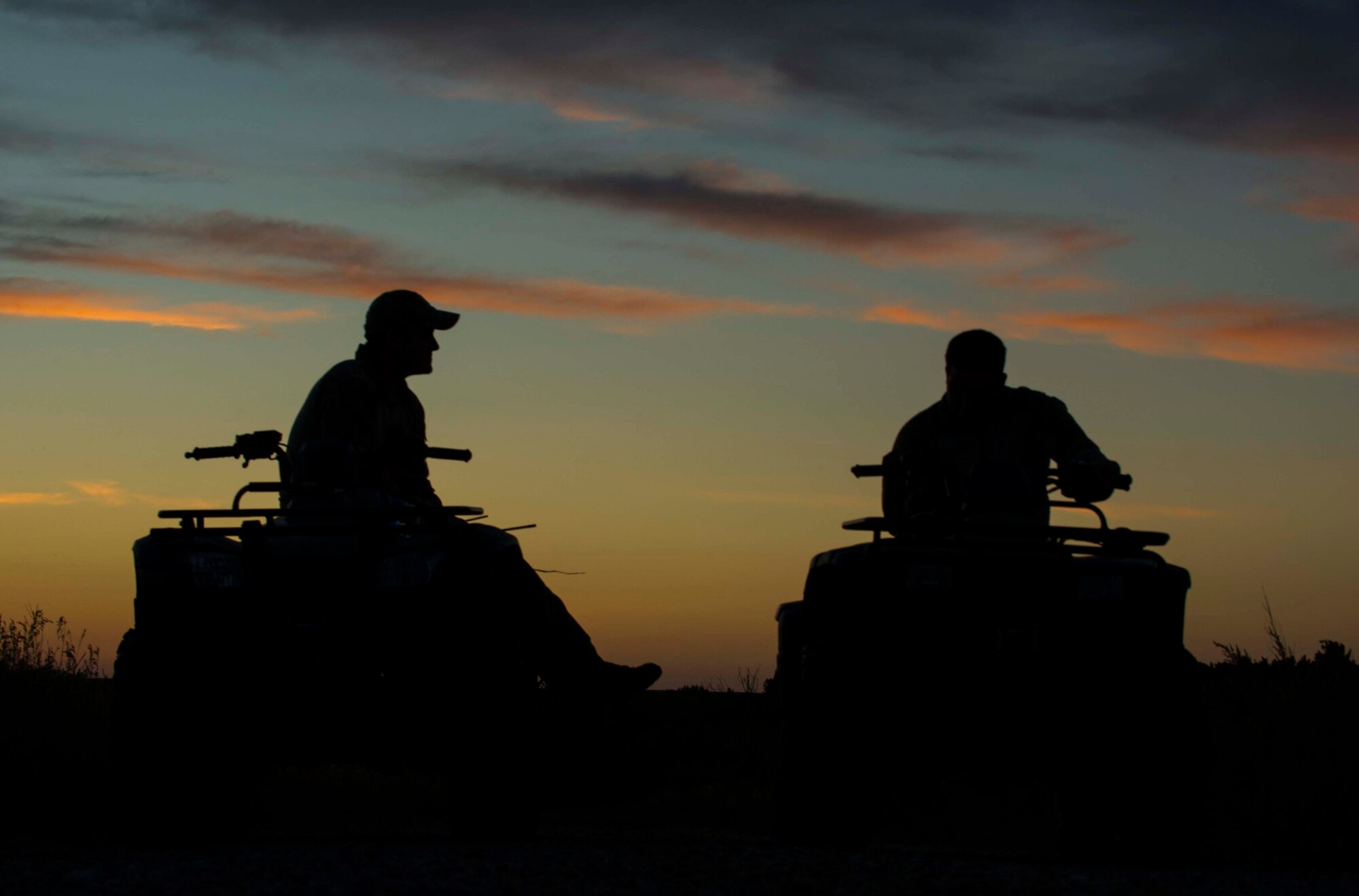 Tech. Sgt. Clifton Cleveland and Staff Sgt. Anthony Barrette, 5th Operations Support Squadron survival, evasion, resistance and escape specialists, sit on ATVs during SERE training in Garrison, N.D., Aug. 11, 2016. During a rescue scenario, Cleveland and Barrette acted as friendly forces to Airmen who were scattered around the training site. (U.S. Air Force photo/Senior Airman Apryl Hall)
