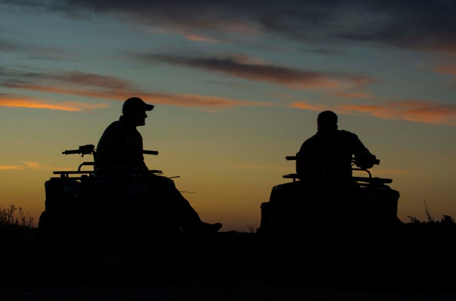 Tech. Sgt. Clifton Cleveland and Staff Sgt. Anthony Barrette, 5th Operations Support Squadron survival, evasion, resistance and escape specialists, sit on ATVs during SERE training in Garrison, N.D., Aug. 11, 2016. During a rescue scenario, Cleveland and Barrette acted as friendly forces to Airmen who were scattered around the training site. (U.S. Air Force photo/Senior Airman Apryl Hall)