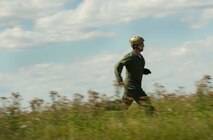A Team Minot Airman runs to a helicopter hoist during survival, evasion, resistance and escape training in Garrison, N.D., Aug. 11, 2016. Aircrew members are required to complete SERE training to prepare themselves for potential hostile situations. (U.S. Air Force photo/Senior Airman Apryl Hall)